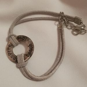 Teacher's bracelet says "Inspire Teach Love"